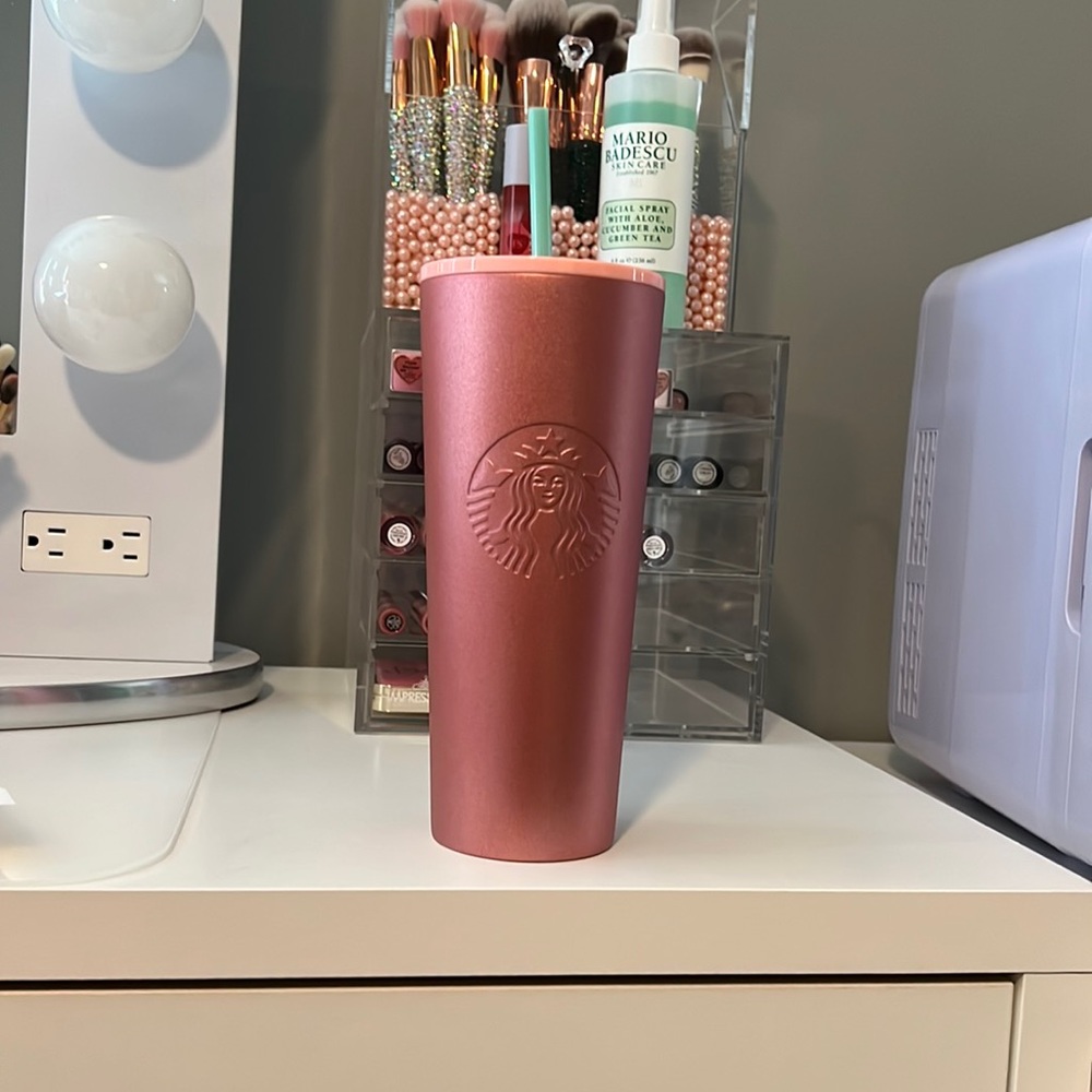Pink glittery 24 ounce Tumblr thermal with light green straw keeps drinks cold